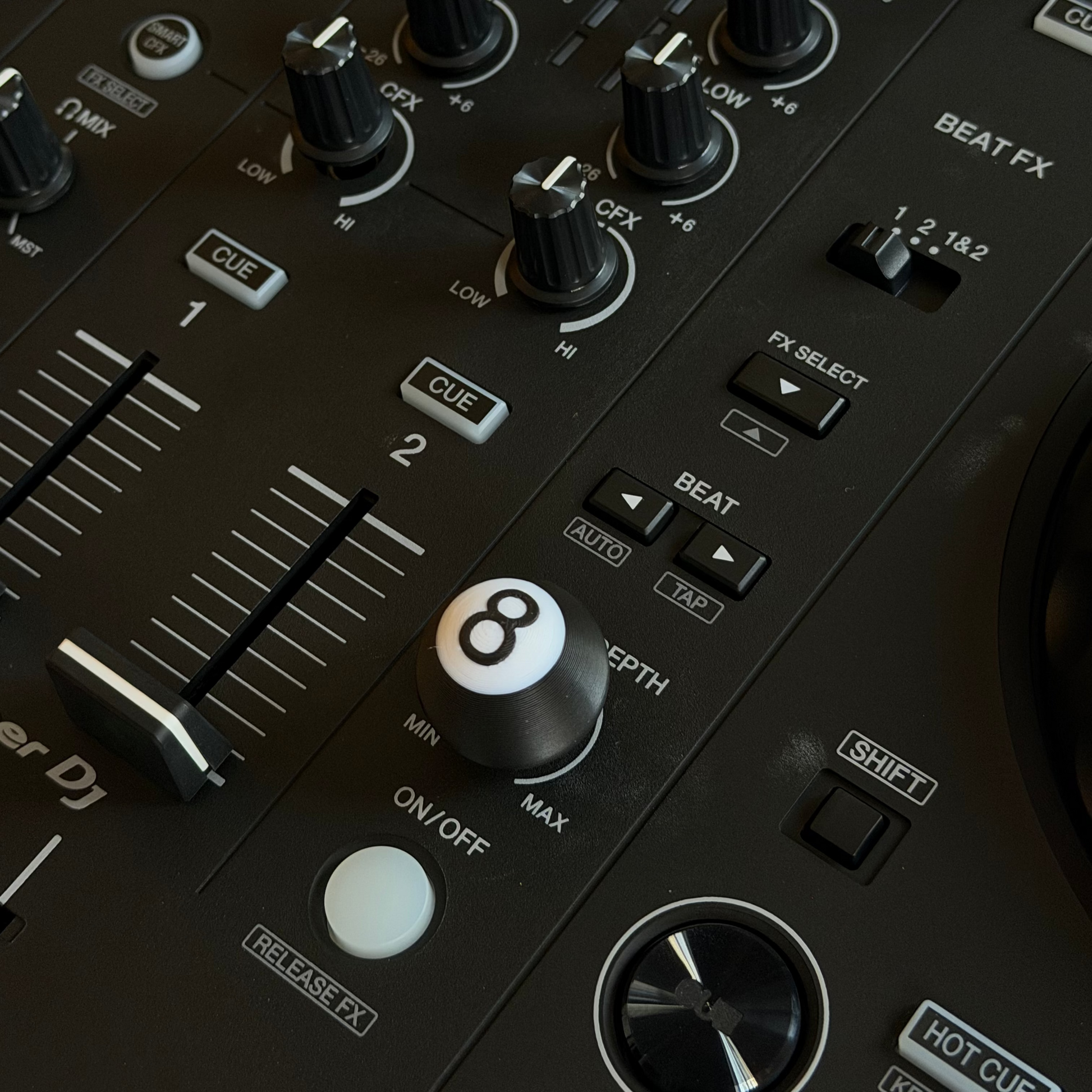 Close-up of a DJ mixer with knobs and controls